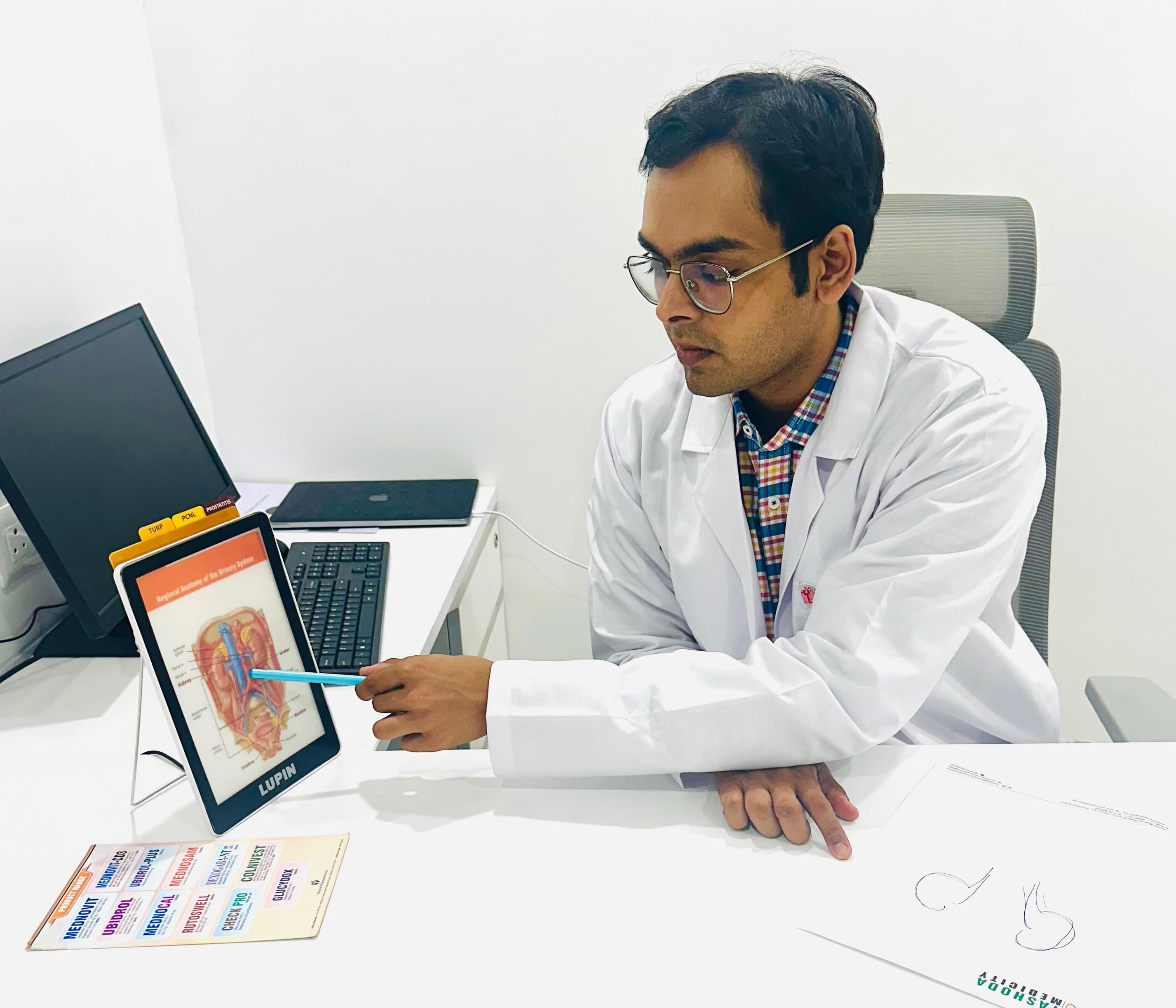 Dr. Keshav Agarwal explaining urological conditions to patients using advanced digital technology